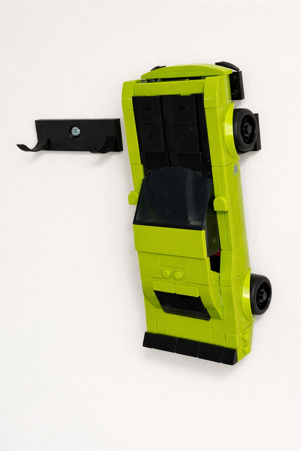 Lime green Speed Champions car mounted on white wall next to empty bracket with screw