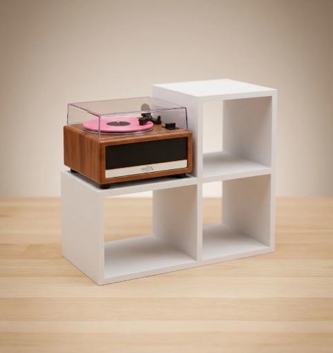 White mini vinyl display stand with a mini record player on the platform and three open slots