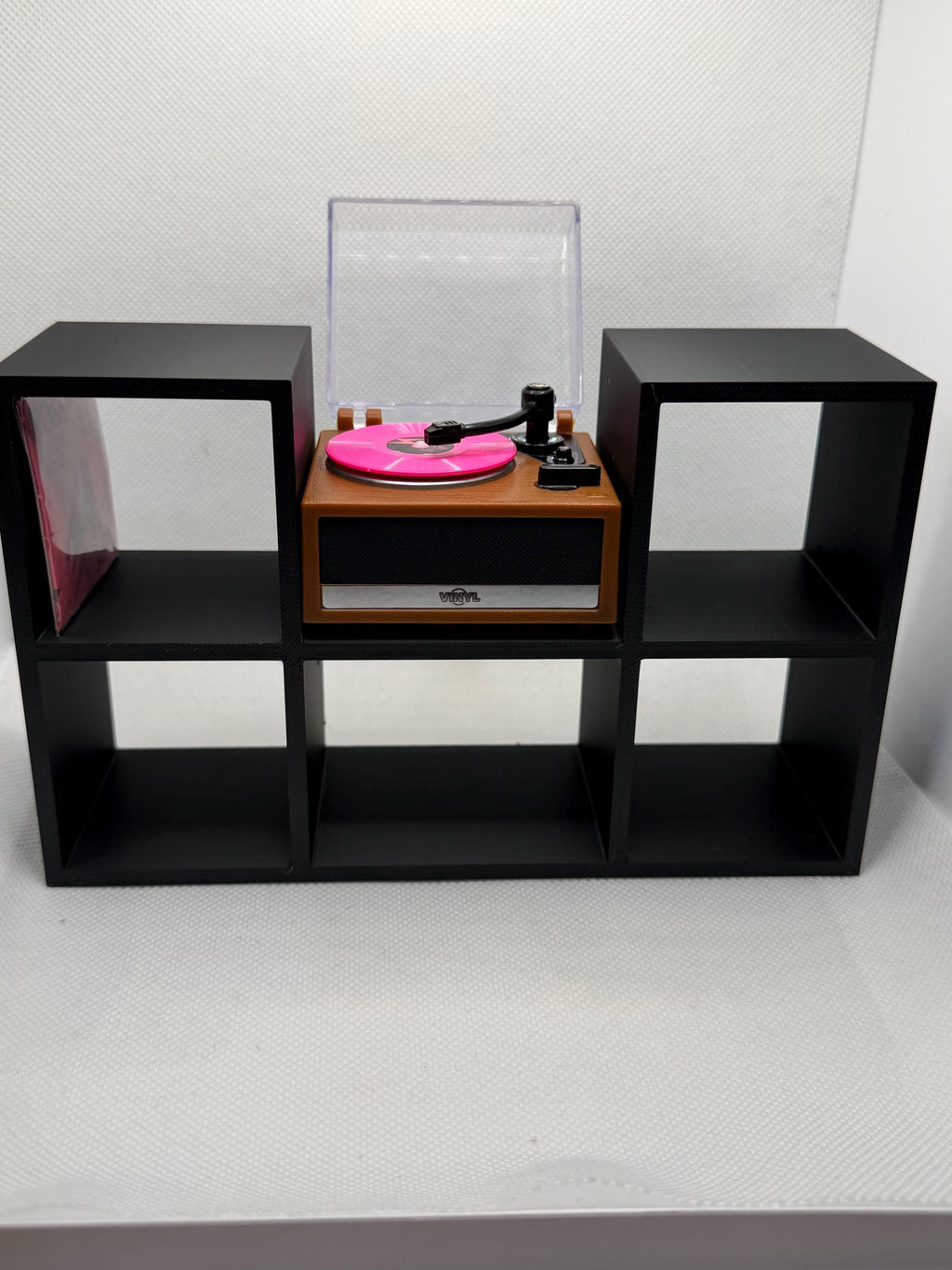 Black 5-slot mini record holder with a mini record player in the center bay and a mini record in a side slot