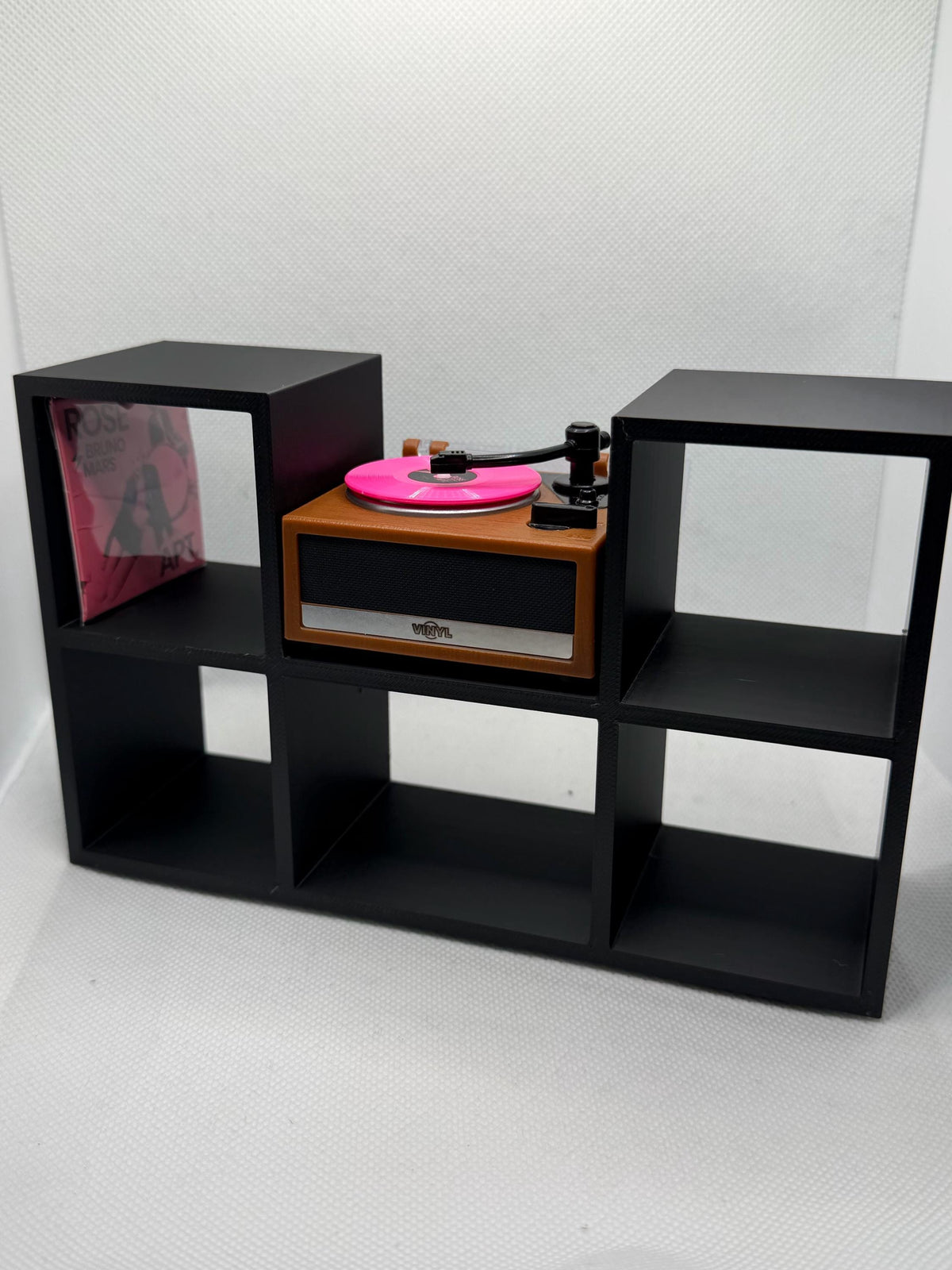Black mini vinyl display stand with a mini record player, angled side view
