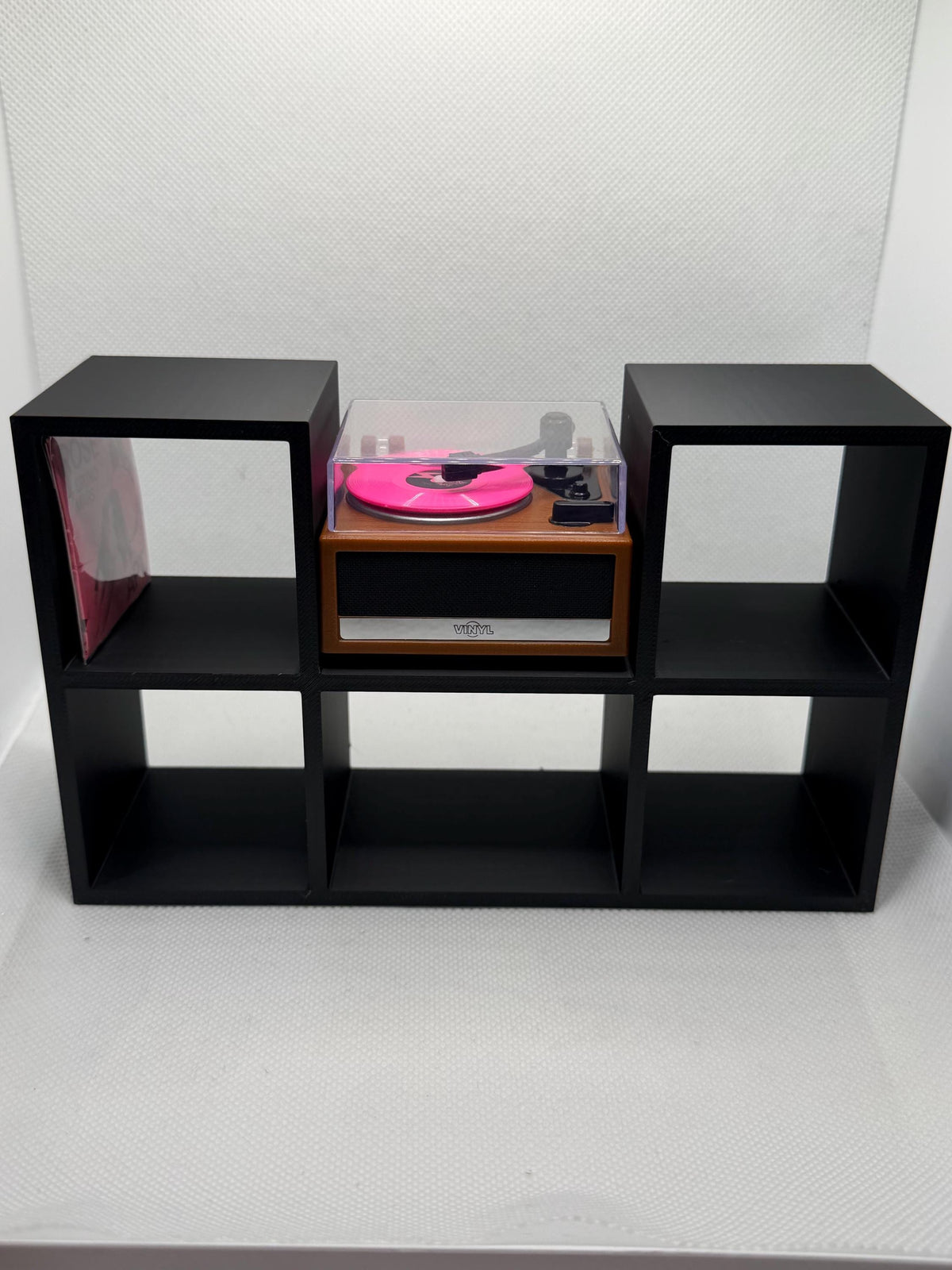 Black 5-slot mini record shelf with a mini record player in the center bay, front view