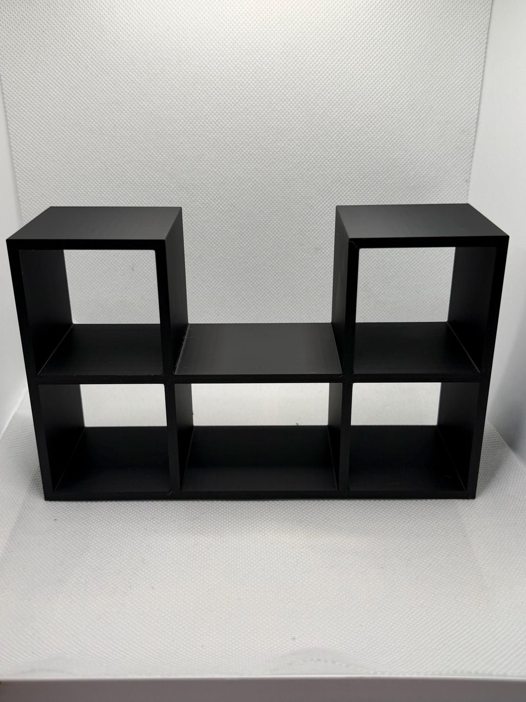 Empty black mini record holder showing five record slots and the center player bay